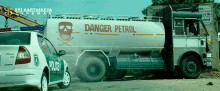 a tanker truck with danger petrol written on the side