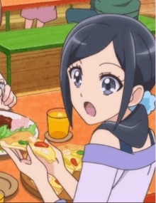 a girl is sitting at a table with a slice of pizza and a glass of orange juice