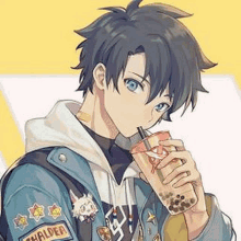 a boy in a denim jacket is drinking a cup of bubble tea .