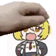 a hand is holding a cartoon character 's head with a towel over it .