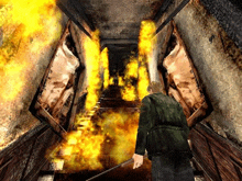 a man in a video game is holding a gun in a hallway that is on fire