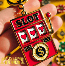 a person is holding a slot machine shaped keychain