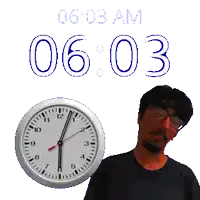 a man with glasses stands in front of a clock that says 6:03 am