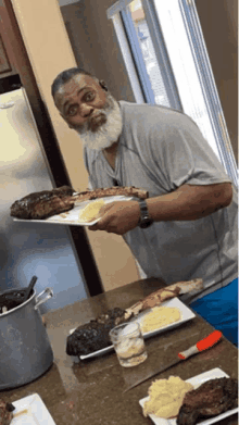 a man with a beard is holding a plate of food