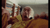 a man with a shocked look on his face stands in front of a bookshelf