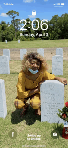 a woman is kneeling in front of a grave in a cemetery on sunday april 3