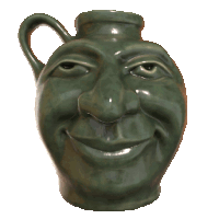 a green pitcher with a smiling face and big teeth