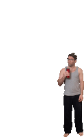 a man in a grey tank top is holding a can of coke