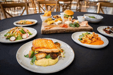 a table with plates of food and a cutting board