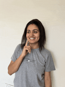 a woman wearing a cotton candy t-shirt is smiling