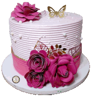 a cake with pink flowers and a gold butterfly on top