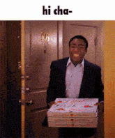 a man in a suit is carrying a stack of pizza boxes and says hi cha