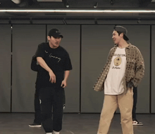 a man wearing a t-shirt that says los customs is dancing with another man