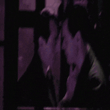 two men are touching each other 's faces in the dark