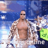 a shirtless man wearing sunglasses is walking down a stage with the words `` todd is online '' written on it .