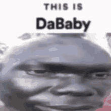 a close up of a black man 's face with the words `` this is dababy '' written on it .