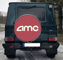 a car with a red tire cover that says amc on it