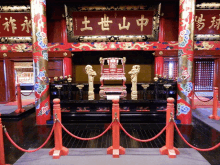 a throne in a temple with chinese writing on the pillars