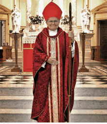 a man in a red robe and red hat is holding a staff