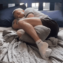 a man wearing nike socks is sleeping on a bed with a blanket