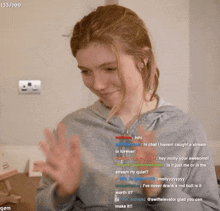 a woman applauds while watching a stream with the number 133/100