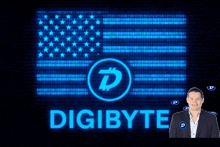 a man stands in front of a digibyte sign