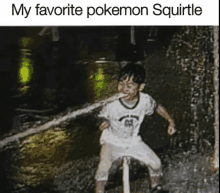 a young boy is squirting water from his mouth while riding a bike in the rain .