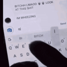 a person is typing on a cell phone with a message that says bitchh lmaoo at this shit im wheezing