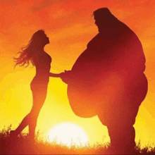 a silhouette of a woman holding a man 's hand at sunset