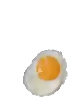 a close up of a fried egg on a white surface