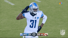 a football player wearing number 31 salutes the crowd