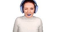 a woman wearing headphones with blue lipstick on her lips