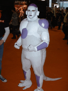 a man in a white and purple costume is standing in front of a death note poster