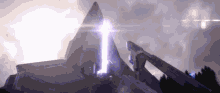 a purple light is coming out of a pyramid on top of a mountain