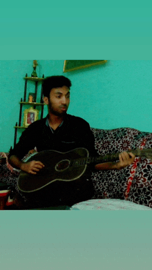 a man playing an acoustic guitar with the letter o on the neck