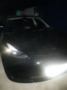 a tesla model 3 is parked in the dark