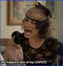 a woman wearing a leopard print hat is screaming and says the happiest day of my life !!!