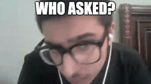 a man wearing glasses and ear buds is making a funny face with the words `` who asked ? ''