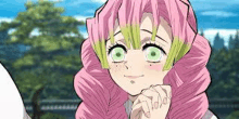 a girl with pink hair and green eyes is smiling with her hands folded .