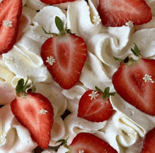 strawberries are on top of whipped cream with small white flowers