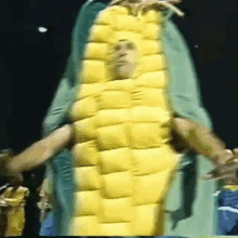 a man in a corn on the cob costume is dancing