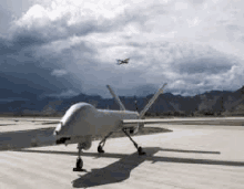 a drone is sitting on top of an airport runway .