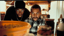 ice cube and a man looking at a bowl of food