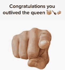 a fist pointing at the camera with the words `` congratulations you outlived the queen '' below it .