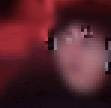 a blurred image of a person 's face with a red and black background