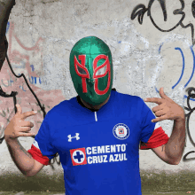 a man wearing a blue under armour shirt with cemento cruz azul on it