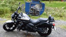 a black and white kawasaki motorcycle is parked on the side of the road