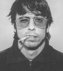a man with a cigarette in his mouth wearing sunglasses