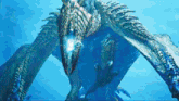 a blue dragon with a light coming out of its mouth is swimming in the water