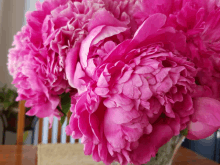 a bouquet of pink flowers in a vase on a table